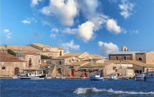 a group of boats are docked in a harbor at 1 Bedroom Nice Apartment In Marzamemi in Marzamemi