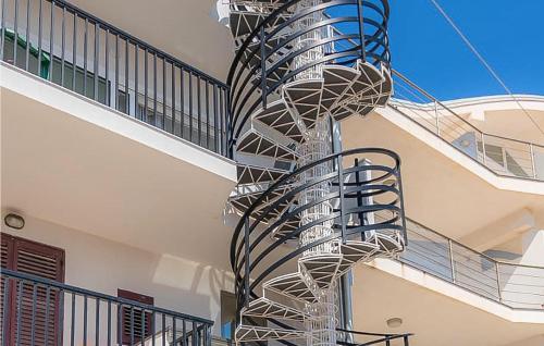 a spiral staircase in the side of a building at 1 Bedroom Nice Apartment In Marzamemi in Marzamemi