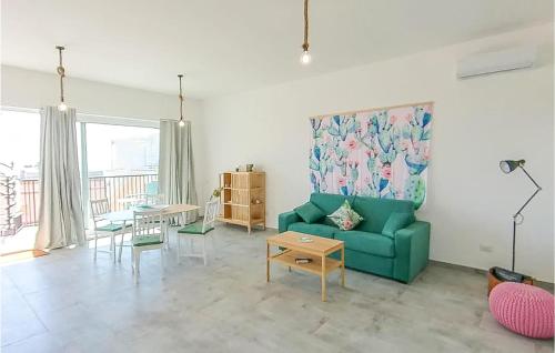 a living room with a green couch and a table at 1 Bedroom Nice Apartment In Marzamemi in Marzamemi