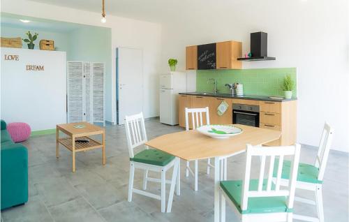 a kitchen and dining room with a table and chairs at 1 Bedroom Nice Apartment In Marzamemi in Marzamemi