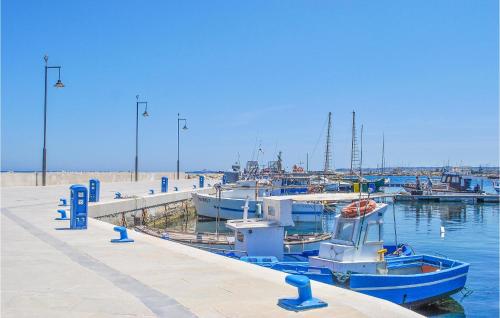 a group of boats docked at a dock at 1 Bedroom Nice Apartment In Marzamemi in Marzamemi