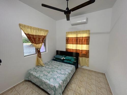 a bedroom with a bed and a window at AA Burger Homestay for Musliim Only in Banting