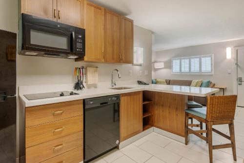 a kitchen with a sink and a microwave at Best Western Plus Jekyll Island in Jekyll Island
