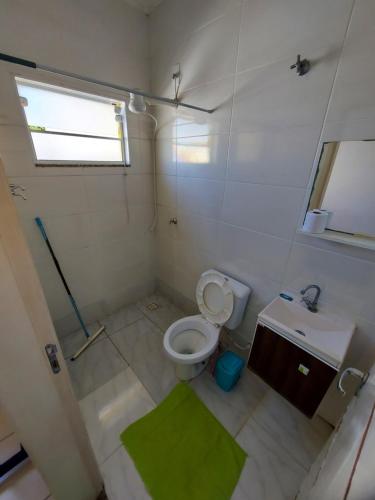 a small bathroom with a toilet and a sink at Quartos com Banheiros privativos - Hospedagem Recanto do Luar in Taubaté