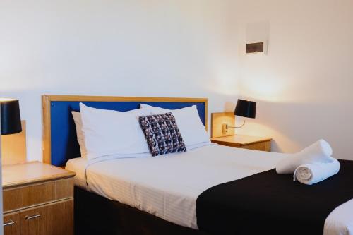 a bedroom with a large bed and two night stands at Comfort Inn Traralgon in Traralgon