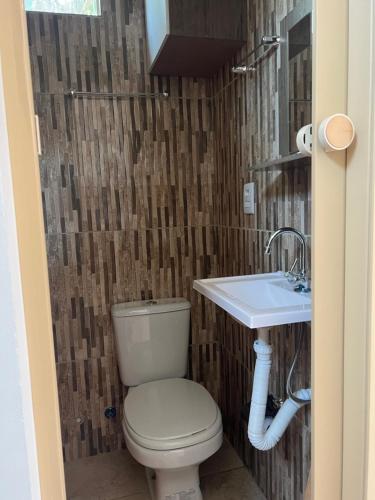 a bathroom with a toilet and a sink at APARTAMENTO MOBILIADO in Boa Vista