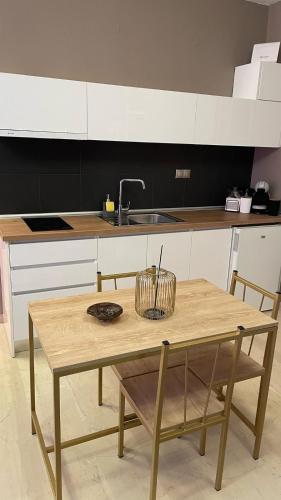 a kitchen with a wooden table and a sink at Marizas luxury suites #1 in Thessaloniki