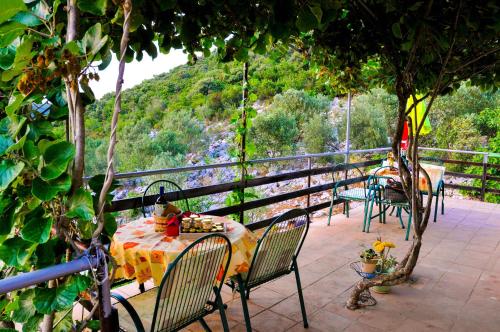 a patio with a table and chairs with a view at Bellavista Peljesac Peninsula in Dubrava
