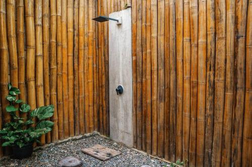 a wooden fence with a door on it at The Verge Cebu Beachfront King Bed Pool Villa - 12 Minutes to Kawasan Falls Canyoneering in Badian