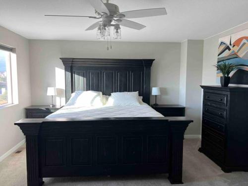 a bedroom with a large bed with a ceiling fan at *Your Colorado Escape* in Commerce City