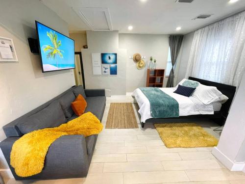 a living room with a bed and a couch at Orange You Glad you came in Miami