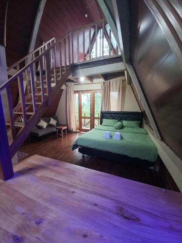 a bedroom with a bed in a room with stairs at Agora Home in Wonosobo
