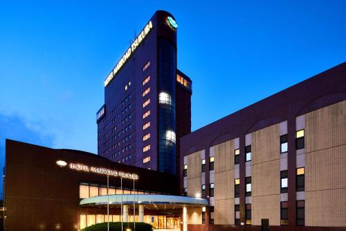 a tall building with a sign on top of it at Hotel Marroad Tsukuba in Tsuchiura