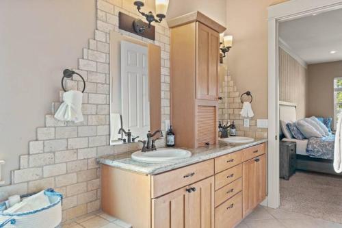 a bathroom with two sinks and a brick wall at Upscale Huge Home 2 Decks w Views 2 Living Rooms in Spokane