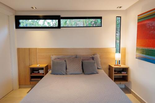 a bedroom with a bed with two pillows and a window at Reserva Cabanas in Balsa Nova