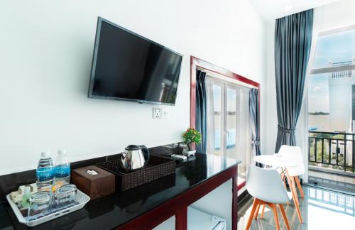 a living room with a flat screen tv on a wall at Koh Dach View Boutique Hotel in Phnom Penh