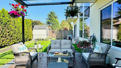 a patio with a couch and chairs and a table at Quiet Room in Richmond in Richmond