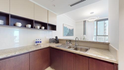 a kitchen with a sink and a counter top at Primestay - Creek Residences South Tower 3, Creek Harbour in Dubai