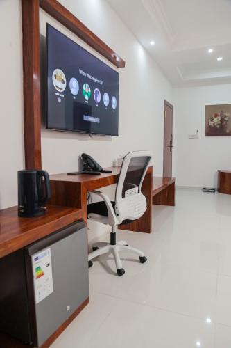an office with a desk and a chair and a screen at Hotel Totara in Dar es Salaam