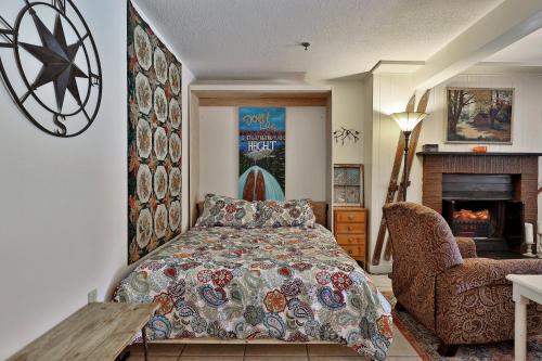 a bedroom with a bed and a fireplace at Mountain Green Condo 3A10 condo in Killington