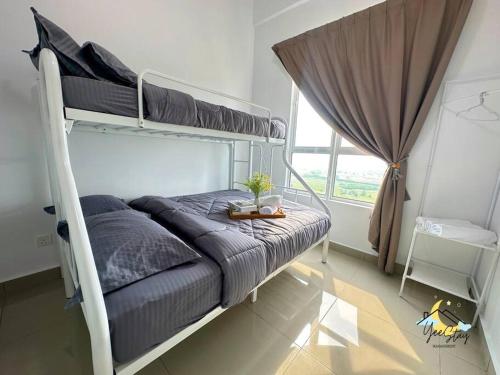 a bedroom with two bunk beds and a window at Amber Cove 7pax/VideoGame/5min to Jonker in Melaka