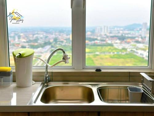 a kitchen sink in front of a window at Amber Cove 7pax/VideoGame/5min to Jonker in Melaka