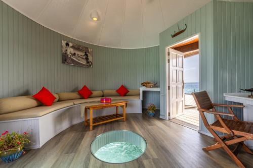 a living room with a couch and a table at Nika Island Resort & Spa, Maldives in Nika Island
