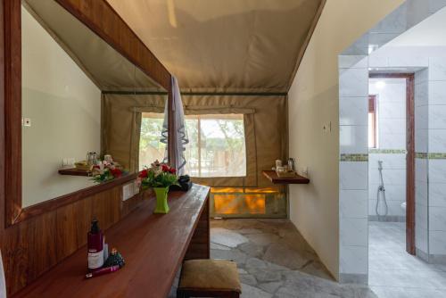 a living room with a wooden table in a house at Sentrim Mara Lodge in Ololaimutiek