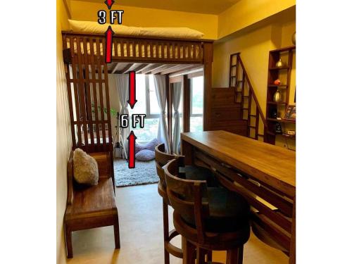 a dining room with a loft bed and a table at Penthouse Condo Studio Unit CENTRIO TOWER w/ Stove in Cagayan de Oro