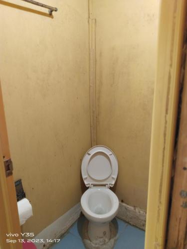 a bathroom with a white toilet in a stall at Shirley's Cottage - Pamilacan Island in Pamilacan