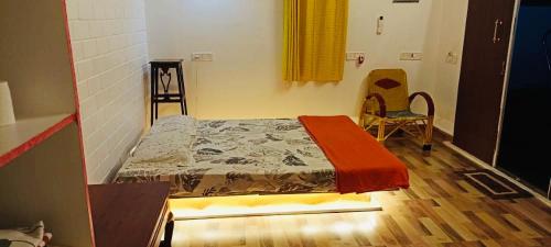 a bedroom with a bed and a table and chairs at Bleu & Blanc in Puducherry