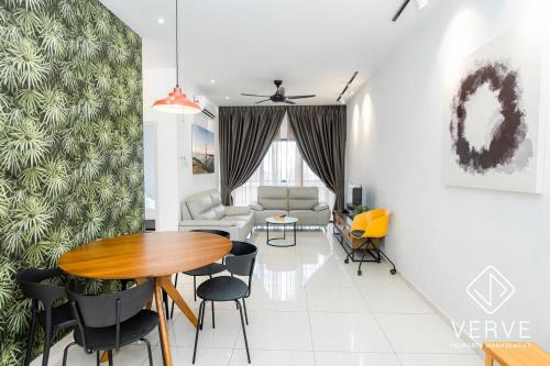 a dining room and living room with a table and chairs at Ipoh Horizon Infinity Pool Suites by Verve in Ipoh