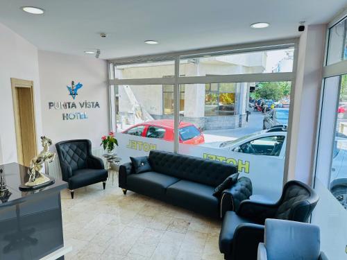 a salon with a couch and chairs in a room at Punta Vista Otel in Izmir