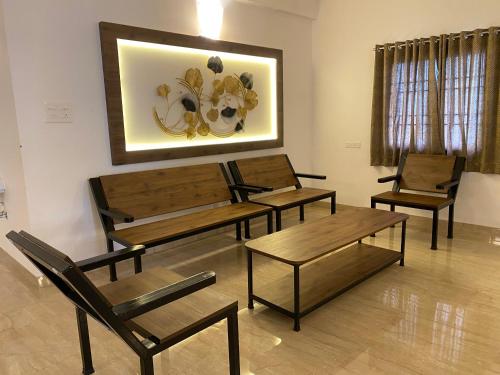 a room with tables and chairs and a painting on the wall at La Tamara Luxury - TIE Hotels & Resorts in Pondicherry