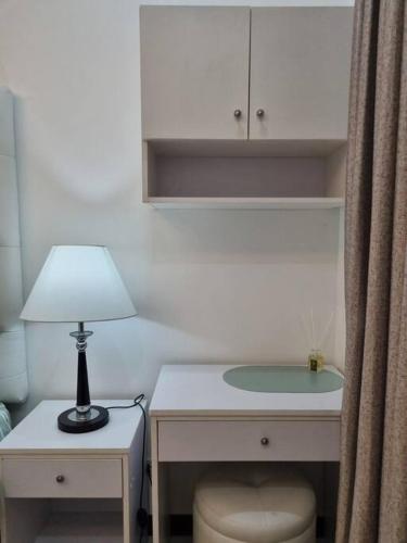 a desk with a lamp and a table with a chair at Chic Studio 5 min walk to Cebu Business Park/Ayala in Cebu City