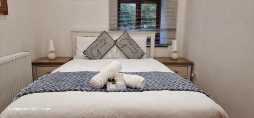 a bedroom with a bed with a stuffed animal on it at Luxury-Immaculate-Cosy 2-Bed House in Plymouth in Plymouth