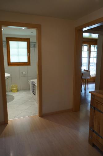 a living room with a door open to a bathroom at Haus Solvay mit freier Matterhornsicht in Zermatt