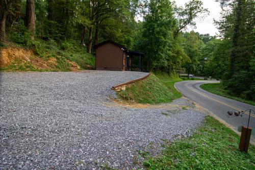 a gravel road with a small building on the side of a road at The Lil House in Robbinsville