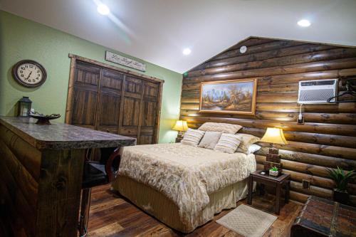 a bedroom with a bed and a wooden wall at The Lil House in Robbinsville
