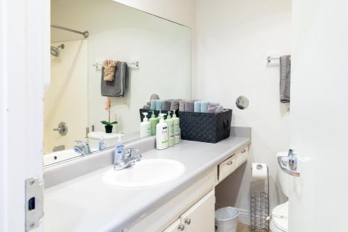 a bathroom with a sink and a mirror at Greely Gaslamp - Loft W Parking & 4 Beds #401 in San Diego