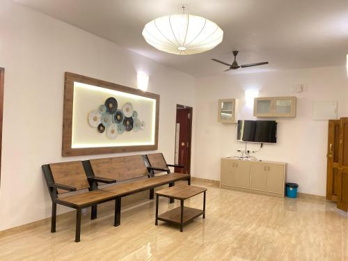 a living room with a wooden table and chairs at La Tamara Luxury - TIE Hotels & Resorts in Pondicherry