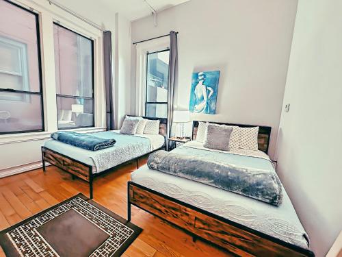 a bedroom with two beds and a window at Gaslamp 2bdrm1ba - W Parking & 4 Beds #304 in San Diego