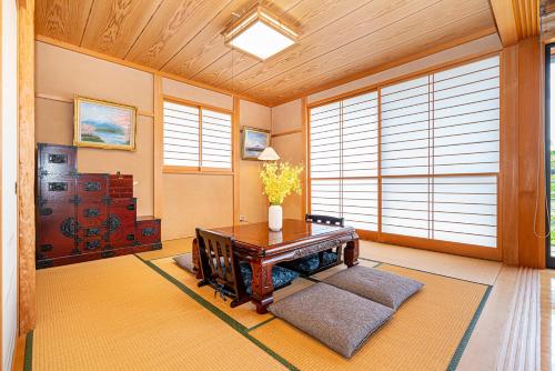 a living room with a table and some windows at View of Mt Fuji Free transportation Bicycle Rental ok 富士山眺望 in Fujikawaguchiko