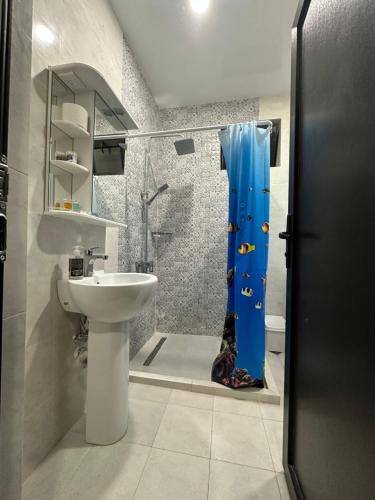 a bathroom with a sink and a shower with a toilet at Guesthouse Chrdili in Tbilisi City