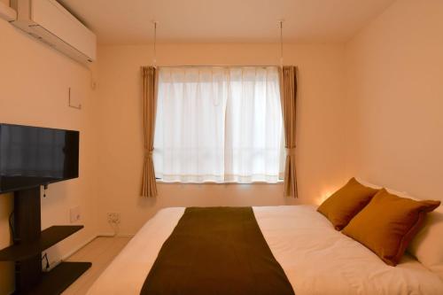 Un pat sau paturi într-o cameră la FL Residence Todai II