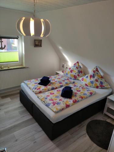 a bedroom with a bed with two bags on it at Ferienwohnung Braun 'Haus Fidi' in Borkum