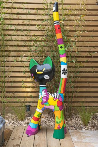 une statue de chat colorée assise sur une terrasse en bois dans l'établissement La villa MaRisKa et son SPA, à Ouistreham