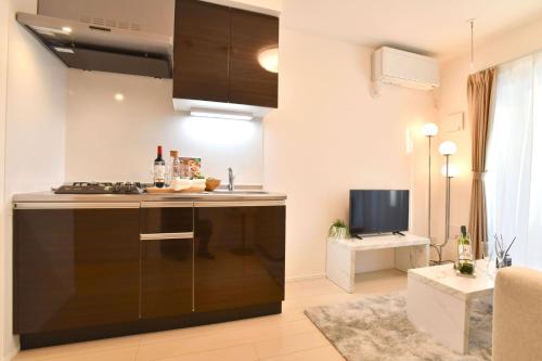 a kitchen with a black island in a room at FL Residence Todai II in Tokyo