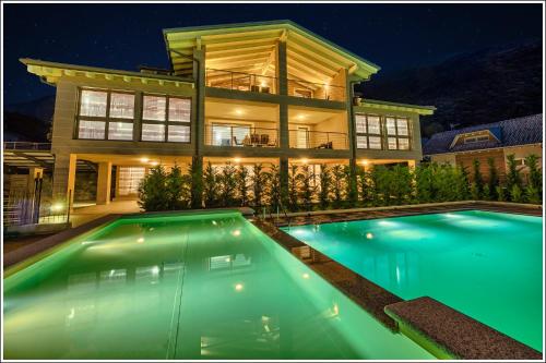 a house with a swimming pool in front of a house at Villa TaDi LaRo Luxury Deluxe Comer See Colico in Colico
