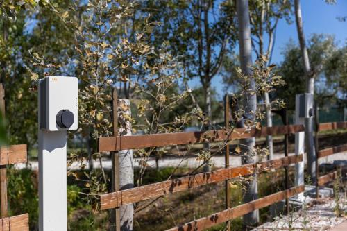 a wooden fence with a security camera on it at Bio Fattoria Mula D'Oro - biofattoriamuladoro it - Organic Food, Nature & Relax in Mulazzano